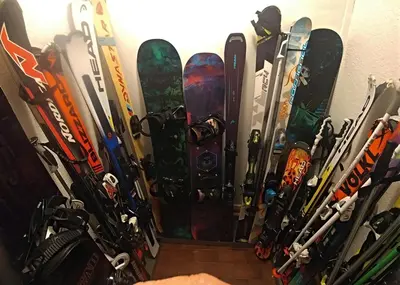 a bunch of snowboards are lined up against a wall at Garni Gabrieli in Corvara in Badia