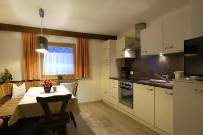 a bedroom with a bed with a blanket on it at Haus Schieder in Castelrotto