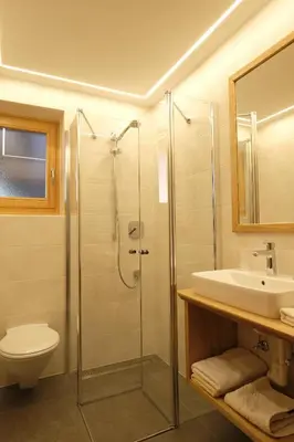a bathroom with a shower and a toilet and a sink at Haus Schieder in Castelrotto