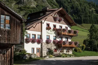 a building with flower boxes on the side of it at Pension Pcei in Picciai