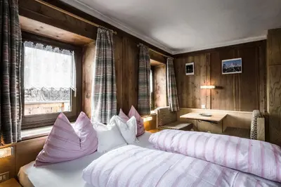 a bedroom with a bed and a desk and a window at Pension Pcei in Picciai