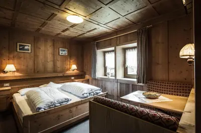 a bedroom with a bed and a table in it at Pension Pcei in Picciai