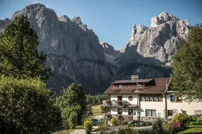a house in front of a mountain at Pension Pcei in Picciai