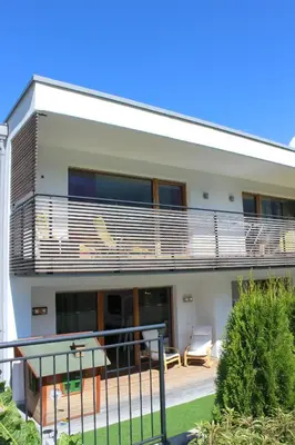 a house with a balcony with a table at Apartment Plan Corones in Brunico