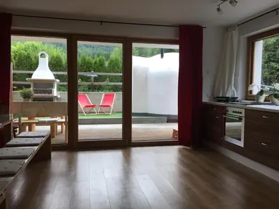 a kitchen with sliding glass doors leading to a patio at Apartment Plan Corones in Brunico