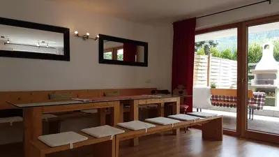 a dining room with a table and a mirror at Apartment Plan Corones in Brunico