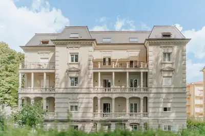 an image of a large white building at Windsor Merano Hotel & Suites in Merano