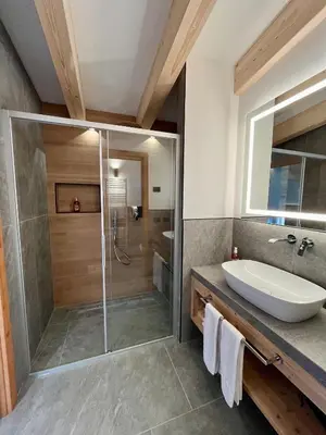 a bathroom with a shower and a sink at Hotel Alpi in Campitello di Fassa