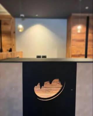 a counter with a logo on it in a room at Hotel Alpi in Campitello di Fassa