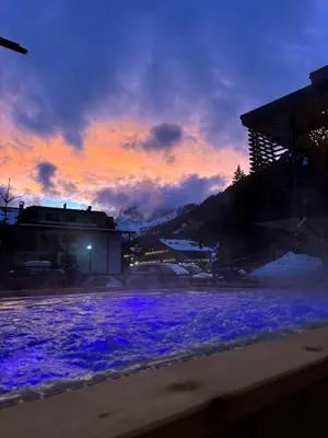 a sunset with purple lights in the snow at Hotel Alpi in Campitello di Fassa