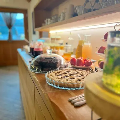 a kitchen counter with a pie on a table at Agriturismo Soreie - Farmstay in Vigo di Fassa