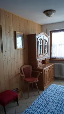 a bedroom with a chair a dresser and a mirror at B&B L'Arca di Noè in Laion