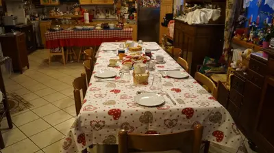 a table in a kitchen with a table cloth on it at B&B L'Arca di Noè in Laion