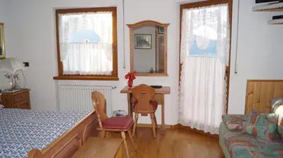 a bedroom with a bed and two chairs and a table at B&B L'Arca di Noè in Laion