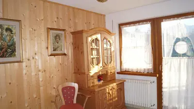 a room with wooden walls and a chair and a cabinet at B&B L'Arca di Noè in Laion