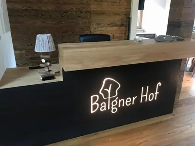 a sign for a barber shop with a chair at Balgnerhof in Laion