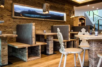 a restaurant with wooden walls and tables and chairs at Balgnerhof in Laion