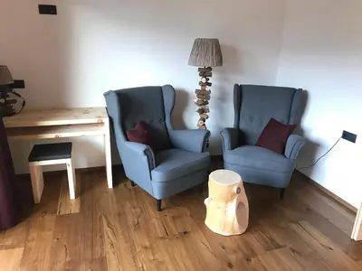 two chairs and a desk and a lamp in a room at Balgnerhof in Laion