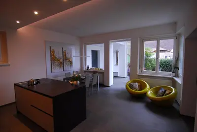 a living room with a table and two yellow chairs at Torilan in Terlano