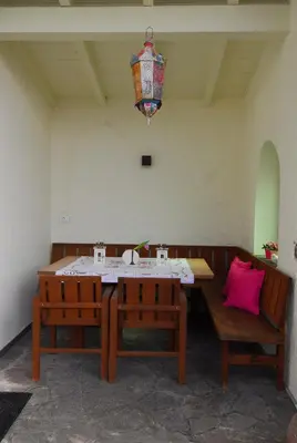a dining room with a table and two benches at Torilan in Terlano