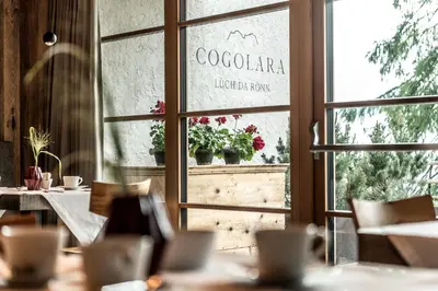 a restaurant with a window with a sign that reads colectoria libello flow at Chalet Cogolara in Colfosco