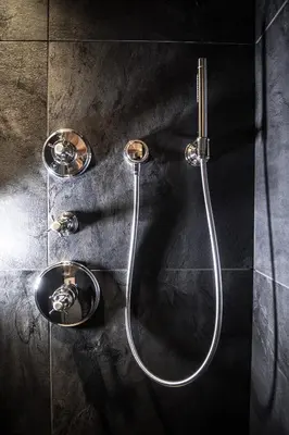 a shower in a bathroom with two faucets at Chalet Cogolara in Colfosco