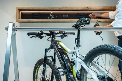 a person holding a bike on a rail at Chalet Cogolara in Colfosco