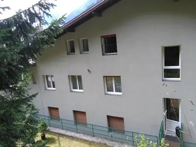 a large white building with many windows at Il Giornalgaio in Canazei