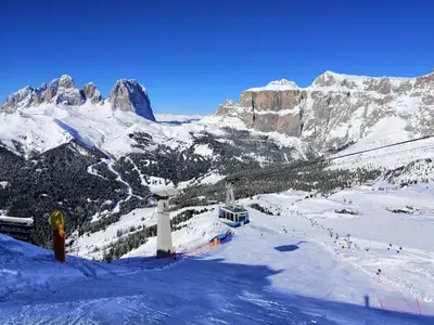 a snow covered mountain with a ski lift at Il Giornalgaio in Canazei