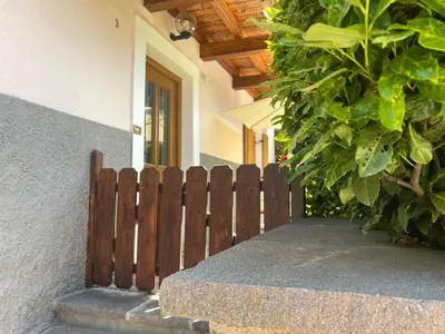 a wooden fence in front of a house at Apartments Bernard in Aldino