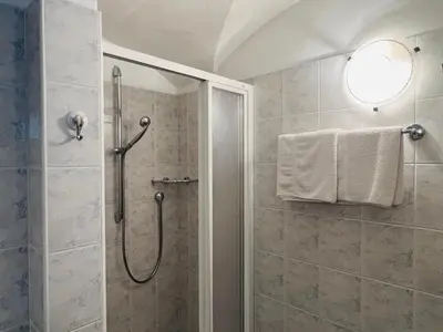 a bathroom with a shower with a glass door at Apartments Bernard in Aldino