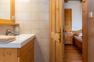 a bathroom with a sink and a toilet in it at Garni Zatzerhof in Castelrotto