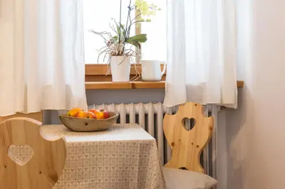 a bowl of fruit sitting on a table next to a window at Garni Zatzerhof in Castelrotto