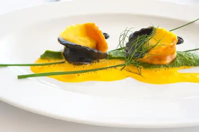 a plate of food on a white plate at Hotel Lambrechtshof in Appiano sulla Strada del Vino
