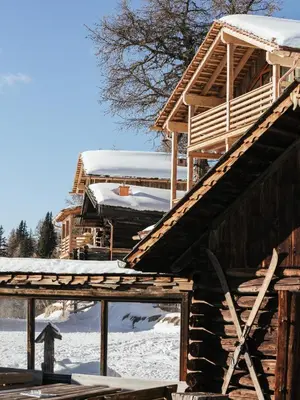 a wooden house with snow on the roof at Rifugio Graziani Hütte in San Vigilio Di Marebbe