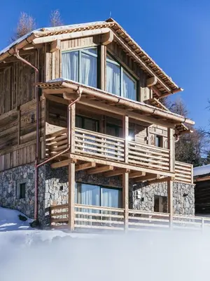 a log cabin with snow on the ground in front of it at Rifugio Graziani Hütte in San Vigilio Di Marebbe