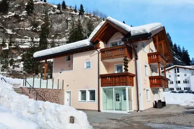 a large building with snow on the side of it at Apartment Plan de Socrep in Santa Cristina in Val Gardena
