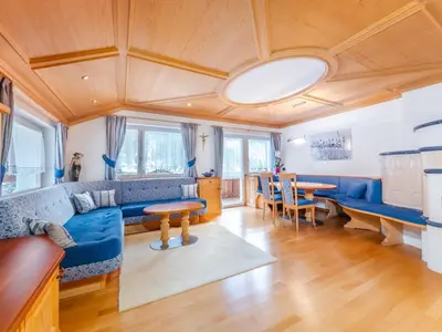a living room with blue couches and a table at Apartment Plan de Socrep in Santa Cristina in Val Gardena
