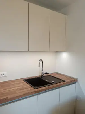 a kitchen with a sink and a stove top oven at Residence Lenzenau in Tirolo