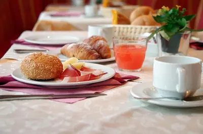 a table with plates of food and coffee and pastries at Mountain B&B - La Scalira in Corvara in Badia