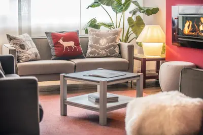 a living room with a couch with pillows and a table at Veronza Clubresidence in Cavalese