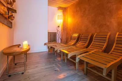 a row of chairs in a room with a candle on a table at Al Sole Clubresidence in Canazei