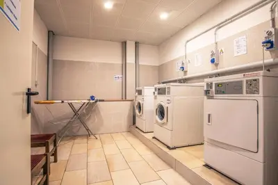 a laundry room with washer and dryer at Al Sole Clubresidence in Canazei
