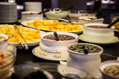 a table with plates of food and bowls of food at Albergo Posta Pederoa in La Valle