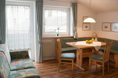 a living room with a table and a couch at Haus Schweitzer - Naturns in Naturno