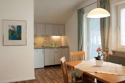 a kitchen and dining room with a table and a dining room at Haus Schweitzer - Naturns in Naturno