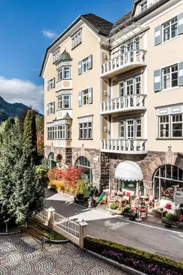 a room with a window and a vase with flowers at Classic Hotel Am Stetteneck in Ortisei