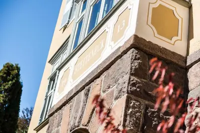 a brick building with a sign on the side of it at Classic Hotel Am Stetteneck in Ortisei