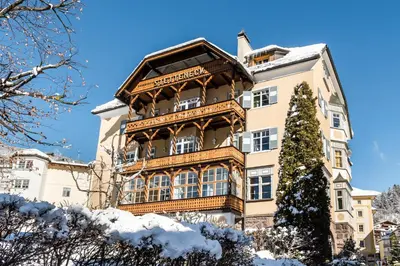 a large building with snow on the ground at Classic Hotel Am Stetteneck in Ortisei
