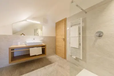 a bathroom with a sink and a shower at Krebslechnerhof in Brunico
